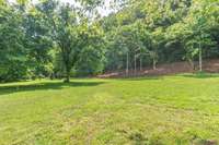 Nice blend of cleared build site abutted by wooded elevation change and bordered on the front of property with year-round creek.