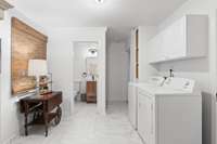 Spacious laundry room with renovated half bath