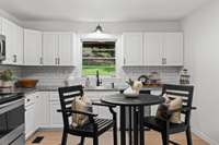 Beautiful white cabinetry and stainless steel appliances shine in this cozy kitchen