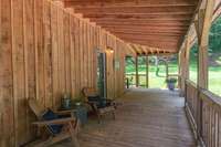 Ample covered porch to relax and enjoy the serenity of the property
