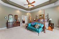 large primary bedroom with vaulted ceilings