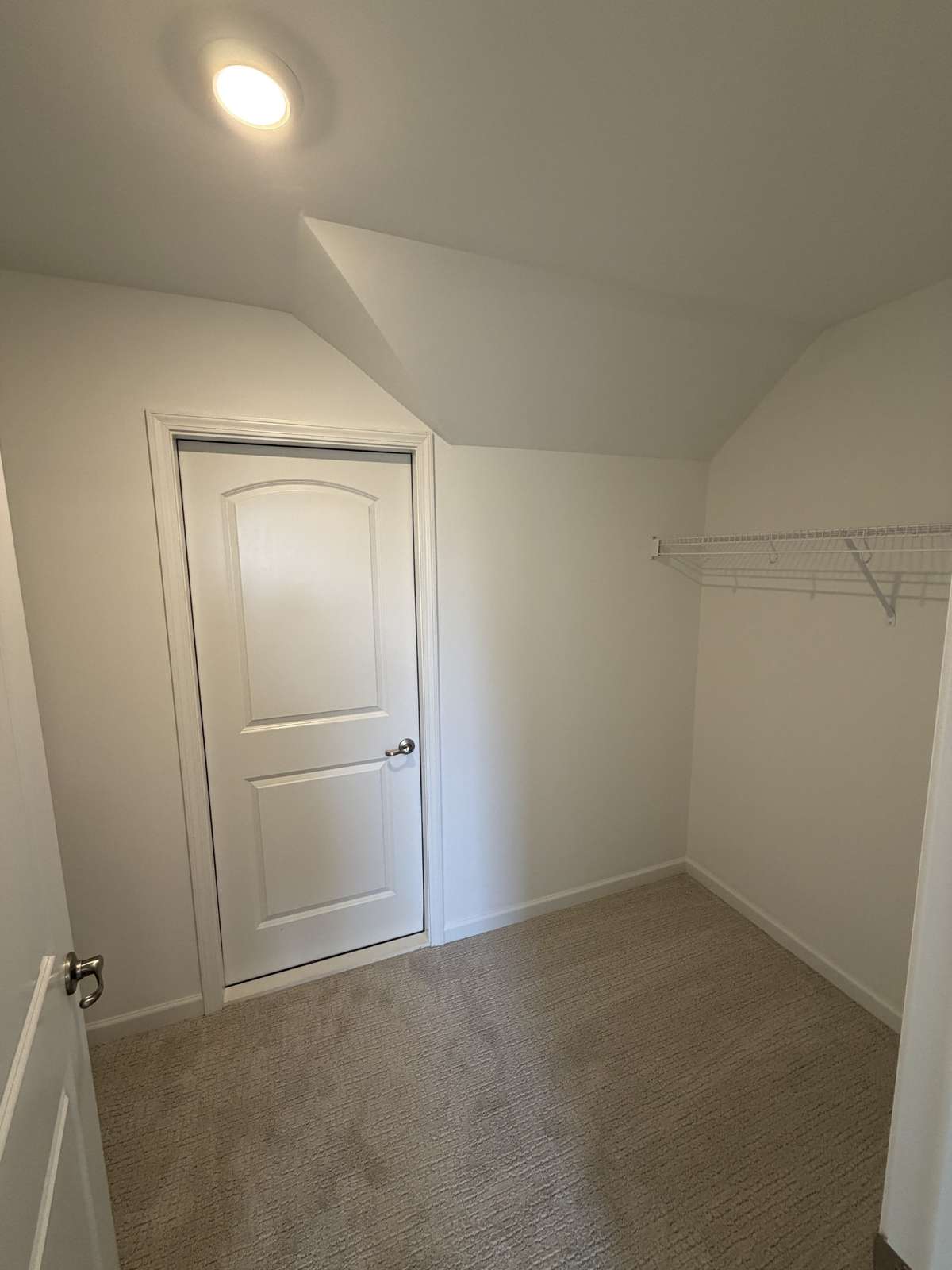 Second level guest bedroom walk-in/through closet to large storage room