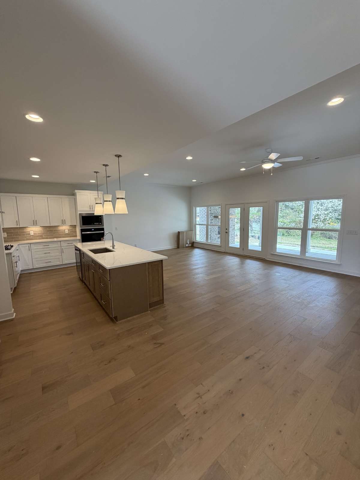 Large wall of windows to your covered back porch with an extended patio and gas fireplace