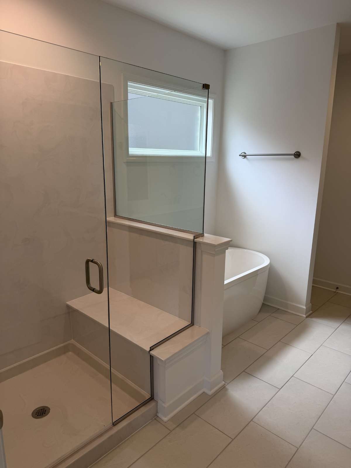 Primary bathroom with a large walk-in shower and freestanding tub