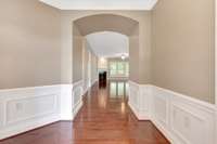 Striking entrance with wainscoting trim and hardwood floors.