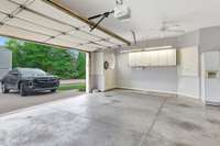 Heated and cooled garage with separate split system. EV Plug in already installed, cabinets, insolated garage door and ceiling fan. This picture show the extra space for golf cart in garage.