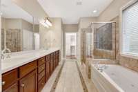 Elegant master bathroom with double vanities, jetted soaking tub, separate shower and huge walk-in closet.