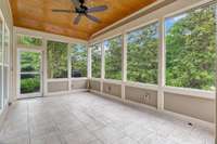 Screened back porch with 16 in tile, electric blinds, ceiling fan and pine ceiling.