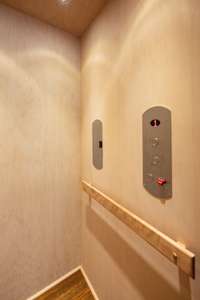 The Elevator has wood paneling on the walls and a solid wood floor.