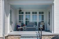 The Covered Porch is located between the Eat-in Kitchen and Primary Bedroom, 10X14. The electric fan has a strong motor and cools the space very well.