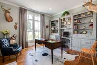 The Office features custom cabinetry thoughtfully designed with a hidden cabinet to neatly store your printer, 13X14.