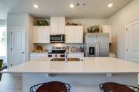 Photos of the staged model home, not of the listing.