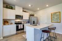 Photos of the staged model home, not of the listing.