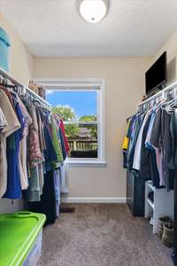Primary closet with beautiful lighting from the window