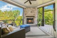 Main floor screen porch with gas fireplace, surround sound and access to the pool