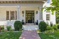 All brick home with gas lanterns added on the inviting front porch