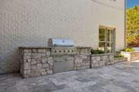 Built in grill with stone accents and landscape lighting