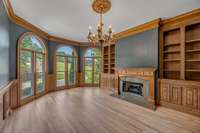 Office/library features gas fireplace, built in bookshelves, stunning wood work, lots of natural light, refinished sand and sealed hardwood floors