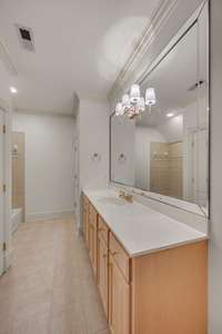 Bedroom 2 - attached bathroom has tile flooring, shower/tub combo, toilet closet, new lighting