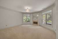Bedroom 5- basement level has gas fireplace, lots of windows overlooking the backyard