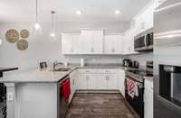 Stainless steel appliances and granite countertops and large cabinets.
