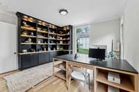 Cozy office on the main floor with custom built-ins and custom desk that will convey.