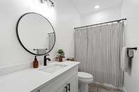 Full bathroom on the main floor between bedrooms 2 and 3.