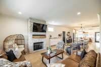 A striking floor-to-ceiling stone fireplace serves as the focal point of the living area.