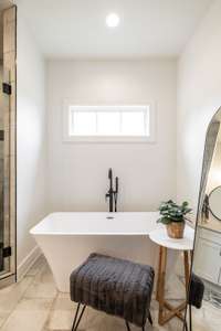 Free-standing tub in the primary bathroom is a statement piece