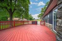 Enjoy summertime on this spacious deck overlooking the backyard.