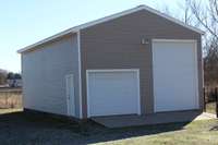 Large building with many possibilities  that has 2 bay doors! One could be for RV and one for a Boat!  Great extra  parking or workshop!