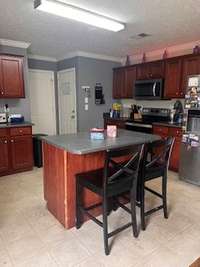 Another view of the Kitchen with Island and Stainless Steel Appliances