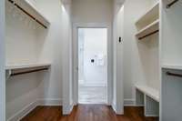 The thoughtfully designed closets are accessed via a pocket door from the primary suite.