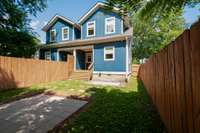 There is a side gate to the right of the house to access the front. Great way for your guests to come into the yard for warm weather parties!
