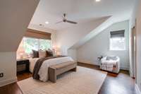 The upper level primary suite is a true retreat offering space for a king sized bed with two night stands and plenty of space for lounge seating.