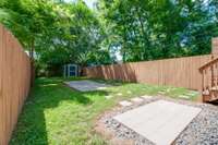 This patio closer to the house is a great spot for all your grilling needs! The storage shed at the end of the yard conveys with the house.