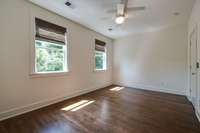 Bedroom #2 on the opposite end of the upper level hallway has beaming hardwood floors, a ceiling fan/light and great natural light.