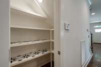 Generous pantry with great built-in shelves for all your organized storage needs!