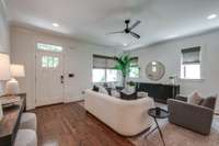 Bright and spacious living room with gorgeous hardwood floors and plenty of natural light.