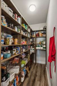 large walk in pantry with built in shelving