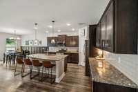 Open plan kitchen with island eating area, dining area and great layout