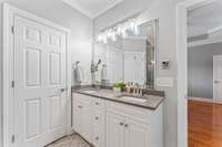 Double vanity bathroom sink and tile flooring. Also see above the light switch you can adjust hot water temperature from the bathroom