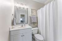 Sleek bathroom near the two bedrooms along main hallway