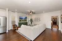 The main living areas, including the spacious family room and hallways, feature rich hardwood flooring that adds warmth and continuity throughout the space.