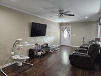 Great room has ceiling fan and TV hanger.
