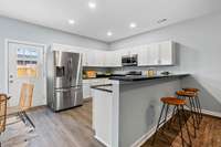 The kitchen features a charming breakfast bar that's perfect for enjoying a snack or your morning coffee.