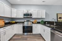 It includes granite counters, a pantry, and tons of cabinet space.