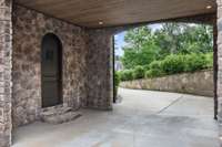 Porte-cochere that accesses one of the two-car garages.