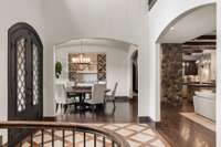 The foyer from the stair landing looking toward the formal dining room and family room.