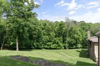 Private back yard. The property boundary is within the tree line. Marcella Vivrette Smith Park with bike paths and Ravenswood Museum is just through the woods.